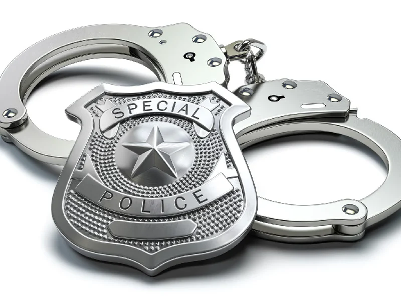 Handcuffs and Special Police Badge on White